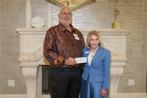 Arol Buntzman, executive chairman of Immokalee Fair Housing Alliance, accepts a $72,000 grant from The League Club to support kitchen cabinets and countertops for the organization’s fourth apartment building in Immokalee.